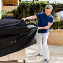 Saber Grills 40-Inch Premium Grill Cover For 670 Series Freestanding Grills 6 Saber Grills 40-Inch Premium Grill Cover For 670 Series Freestanding Grills -BBQGrills Shop Saber Grills 40 Inch Premium Grill Cover for 670 Series Freestanding Grills A67ZZ0118 Lifestyle Putting Cover On